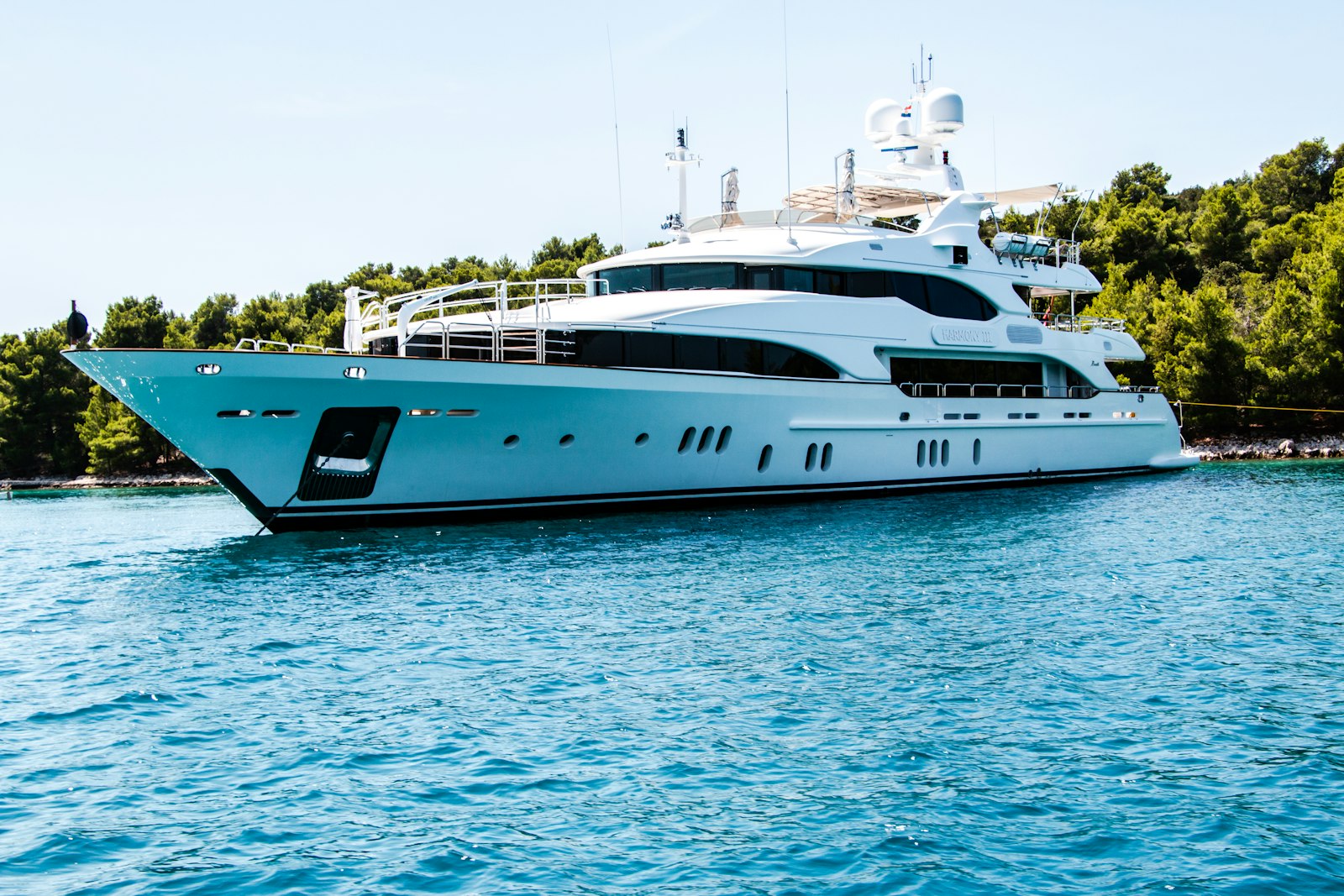 White luxury yacht cruising on open blue water