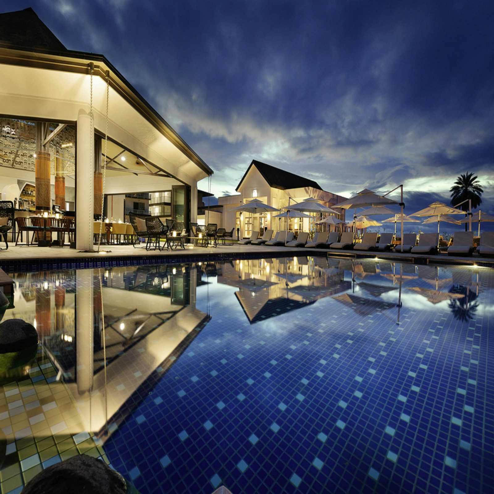 Luxury resort pool and palm trees prepared for seasonal private travel planning