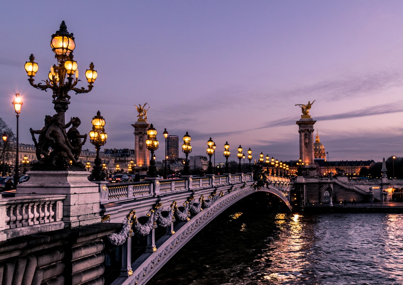 Paris bridge glowing at twilight